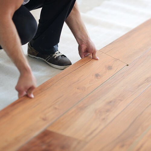 Man installing luxury vinyl flooring in Lexington, SC home