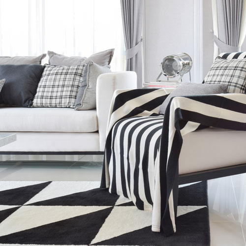 Black and white patterned rug and furniture