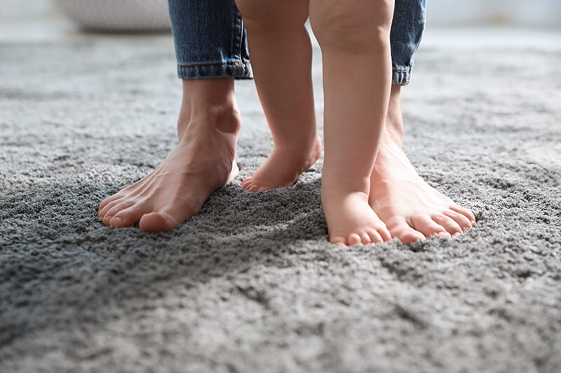 Parent and child walking on durable carpet